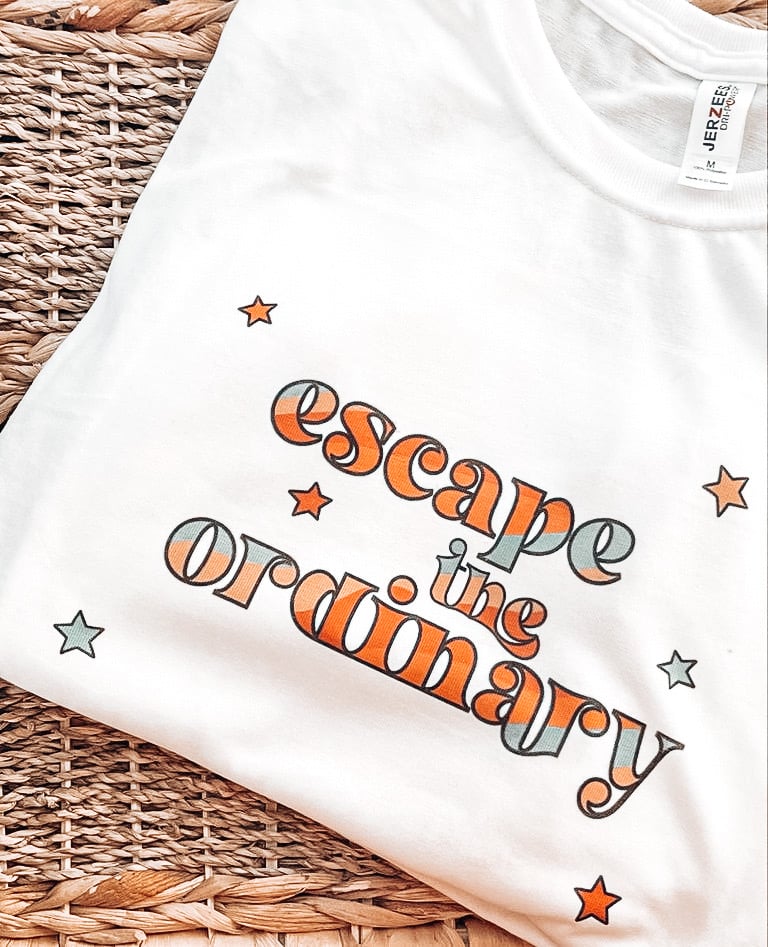 Image of "Escape the ordinary" tshirt.