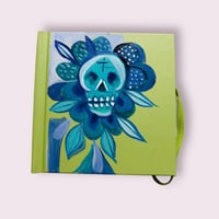 Green sketchbook with Blue skull flower