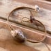 Image of Snake’s head cowrie bracelet on hand braided sinew, your size