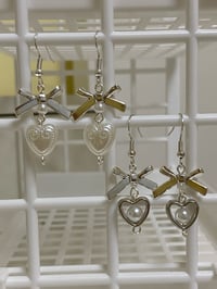 Image 1 of metal bow and heart coquette earrings