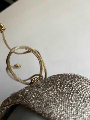 Image of Gold fabric covered bandeau. 