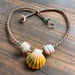 Image of Hawaiian sunrise or moonrise shell necklace with golden pukas and a locking seaglass clasp
