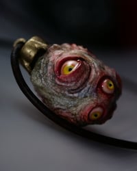 Image 12 of Egg of the King pendant, leather cord, brass hardware, all seeing glowing eyes