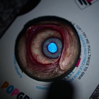 Image 7 of Custom Swappable Phone Grip for smartphones, bright blue reflective pupil, glow in the dark 