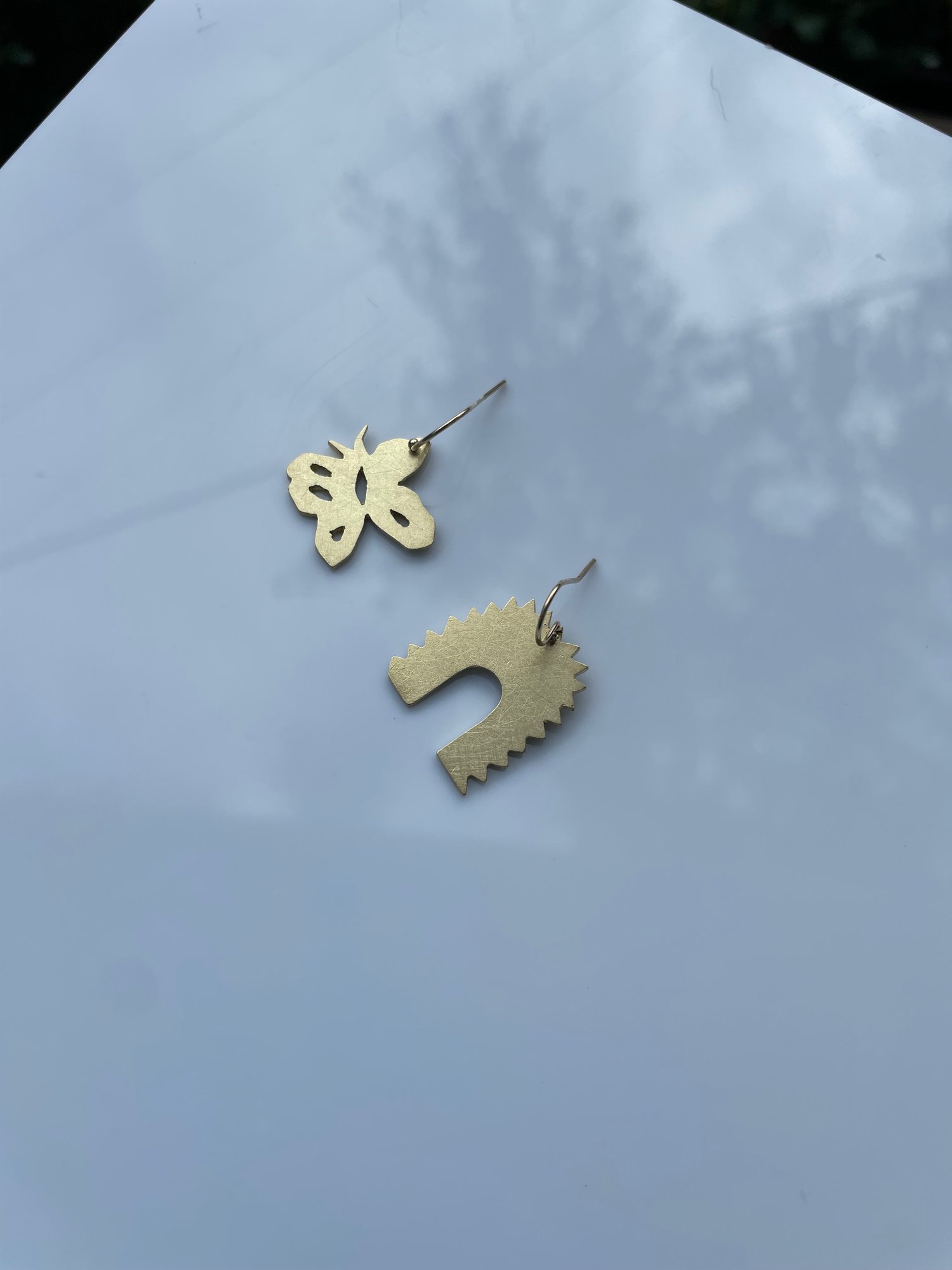 Butterfly and arch earrings in brass